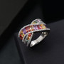 multi color sapphire and white zircon crossover band ring in rhodium over sterling silver shown in a lifestyle photo