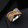 orange sapphire and white zircon crossover band ring in rhodium over sterling silver shown in a lifestyle photo