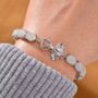 elephant and white jade tennis bracelet in rhodium over sterling silver worn on a wrist