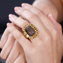 chocolate sapphire citrine and chrome diopside halo cocktail ring in 18k yellow gold over sterling silver worn on a hand