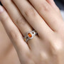hessonite garnet and white zircon halo ring in 18k yellow gold over sterling silver worn on a hand