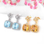 close up of citrine or sky blue topaz and white zircon earrings in 18k yellow gold over sterling silver