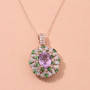 kunzite tsavorite garnet and moissanite pendant necklace in 18k rose gold over sterling silver shown in a lifestyle photo