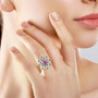 kunzite tsavorite garnet and moissanite ring in 18k rose gold over sterling silver worn on a hand