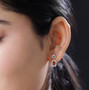 hessonite garnet chrome diopside and zircon drop earrings in rhodium over sterling silver worn on the ear