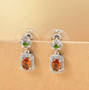 hessonite garnet chrome diopside and zircon drop earrings in rhodium over sterling silver shown in a lifestyle photo