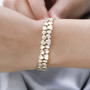 10k yellow gold abstract double row tennis bracelet worn on a wrist