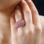 peach opal and rhodolite cluster wide band ring in rhodium over sterling silver worn on a hand