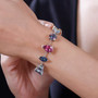 mix shape multi color mystic topaz station link bracelet worn on a wrist