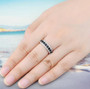black spinel and white zircon band ring in rhodium over sterling silver worn on a hand