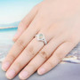 ethiopian opal and white zircon halo ring in rhodium over sterling silver worn on a hand