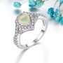 ethiopian opal and white zircon halo ring in rhodium over sterling silver shown in a lifestyle photo