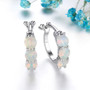 ethiopian opal huggie hoop earrings in rhodium over sterling silver shown in a lifestyle photo
