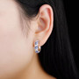 Tanzanite-zircon-hoops-model-GGC712