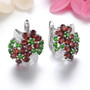 garnet chrome diopside and zircon cluster earrings in rhodium over sterling silver shown in a lifestyle photo