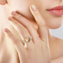 golden south sea pearl yellow sapphire and moissanite halo ring in 18k yellow gold over sterling silver worn on a hand