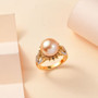 golden south sea pearl yellow sapphire and moissanite halo ring in 18k yellow gold over sterling silver shown in a lifestyle photo