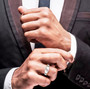 moissanite gents three stone ring in 18k yellow gold and rhodium over sterling silver worn on a hand