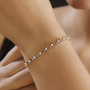 hessonite garnet and moissanite tennis bracelet in rhodium over sterling silver worn on a wrist