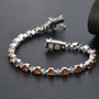 hessonite garnet and moissanite tennis bracelet in rhodium over sterling silver shown in a lifestyle photo