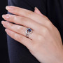 blue kyanite and moissanite heart love knot two ring set in rhodium over sterling silver worn on a hand