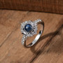 blue star sapphire and white zircon celestial halo ring in rhodium over sterling silver shown in a lifestyle photo