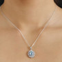 oval blue zircon and white zircon double halo pendant necklace in rhodium over sterling silver worn around the neck