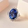 oval color change fluorite and white zircon halo ring in rhodium over sterling silver shown in a lifestyle photo