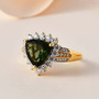 trillion moldavite moissanite and yellow diamond halo ring in 18k yellow gold over sterling silver shown in a lifestyle photo