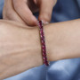 rubellite tourmaline tennis bracelet in 950 platinum worn on a wrist
