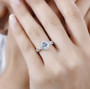 aquamarine pink sapphire and white zircon infinity shank halo ring in rhodium over sterling silver worn on a hand