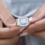 moissanite gents halo ring in rhodium over sterling silver worn on a hand