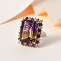 ametrine citrine and amethyst halo ring in rhodium over sterling silver shown in a lifestyle photo