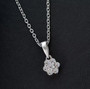 lab diamond cluster pendant necklace in rhodium over sterling silver shown in a lifestyle photo
