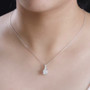 princess cut moissanite and orange sapphire pendant necklace in rhodium over sterling silver worn around the neck