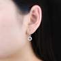 dancing garnet and white zircon double halo dangle earrings in rhodium over sterling silver