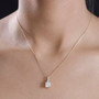 princess cut moissanite and orange sapphire pendant necklace in 18k yellow gold over serling silver worn around the neck