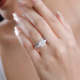 princess cut moissanite and orange sapphire two ring bridal set in rhodium over sterling silver worn on a hand