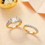 princess cut moissanite and orange sapphire two ring bridal set in 18k yellow gold over sterling silver shown in a lifestyle photo