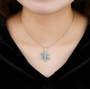 swiss blue topaz and white zircon snowflake pendant necklace in rhodium over sterling silver worn around the neck