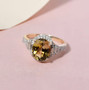 golden tanzanite and diamond halo ring in solid 14k yellow gold shown in a lifestyle photo