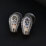 unheated tanzanite green sapphire and zircon earrings in 18k yellow gold over sterling silver shown in a lifestyle photo