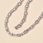 white topaz tennis necklace in rhodium over sterling silver shown in a lifestyle photo