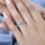blue apatite rubellite tourmaline and diamond halo ring in 10k yellow gold worn on a hand