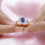 tanzanite and diamond gents ring in 14k yellow gold worn on a hand