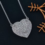 lab grown diamond heart necklace in rhodium over sterling silver shown in a lifestyle photo
