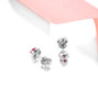 close up of emerald or ruby and white zircon halo stud earrings in rhodium over sterling silver