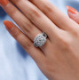 chrysoberyl brown and white zircon halo cluster ring in rhodium over sterling silver worn on a hand