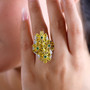 tanzanian yellow opal chrome diopside and zircon flower cluster ring in rhodium over sterling silver worn on a hand