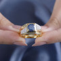 blue and white moissanite gents solitaire ring in 18k yellow gold over sterling silver worn on a hand